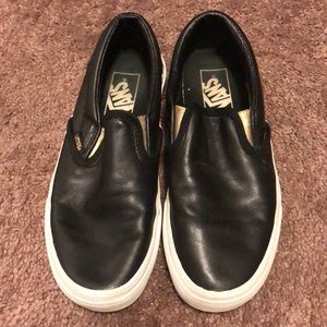 Black leather Vans slip ons